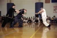 Photo of Sifu Hildreth bending steel rods with his throat